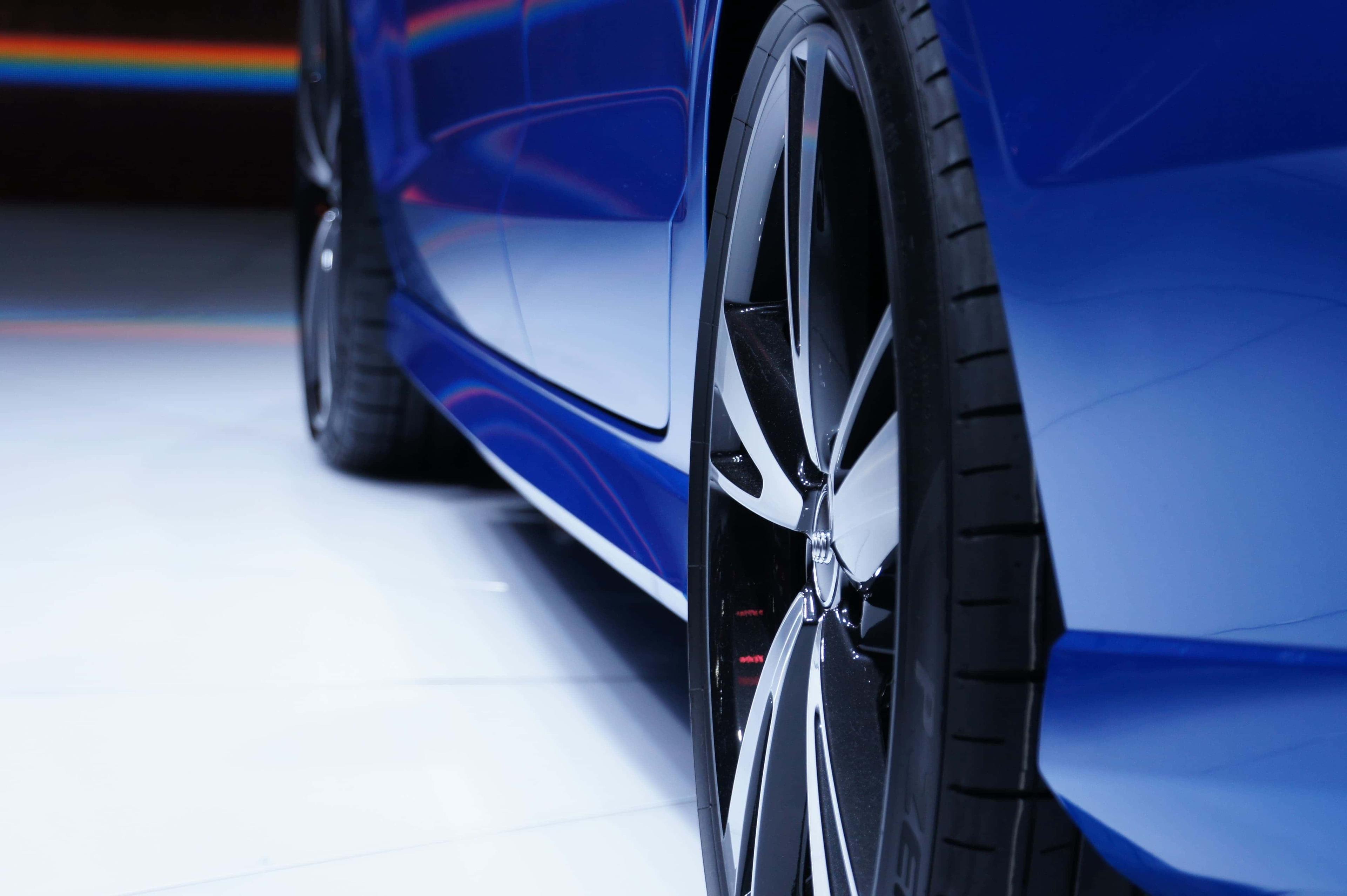 Image of a blue car, focusing on the wheel